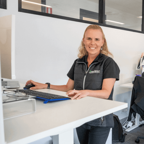 Michelle Harris sits smiling at a computer 