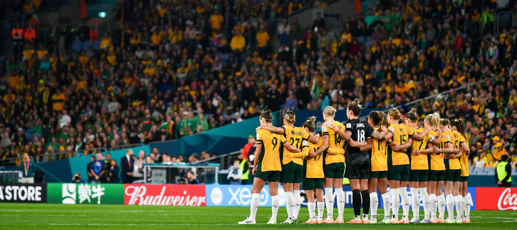 Australian women's soccer team, the Matildas standing arm in arm 